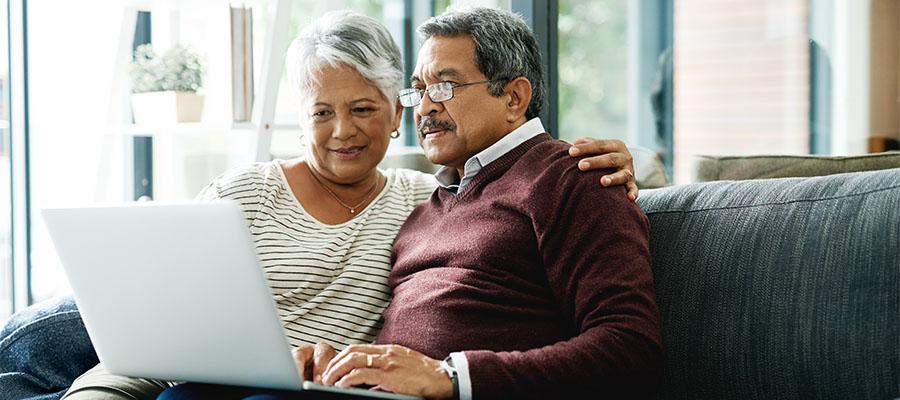 Mature couple researching on their laptop