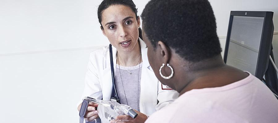 Doctor explains C-PAP mask to patient