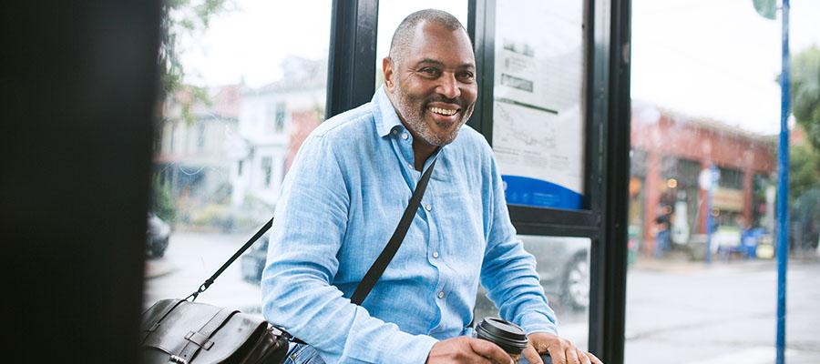 Man smiling waiting for bus