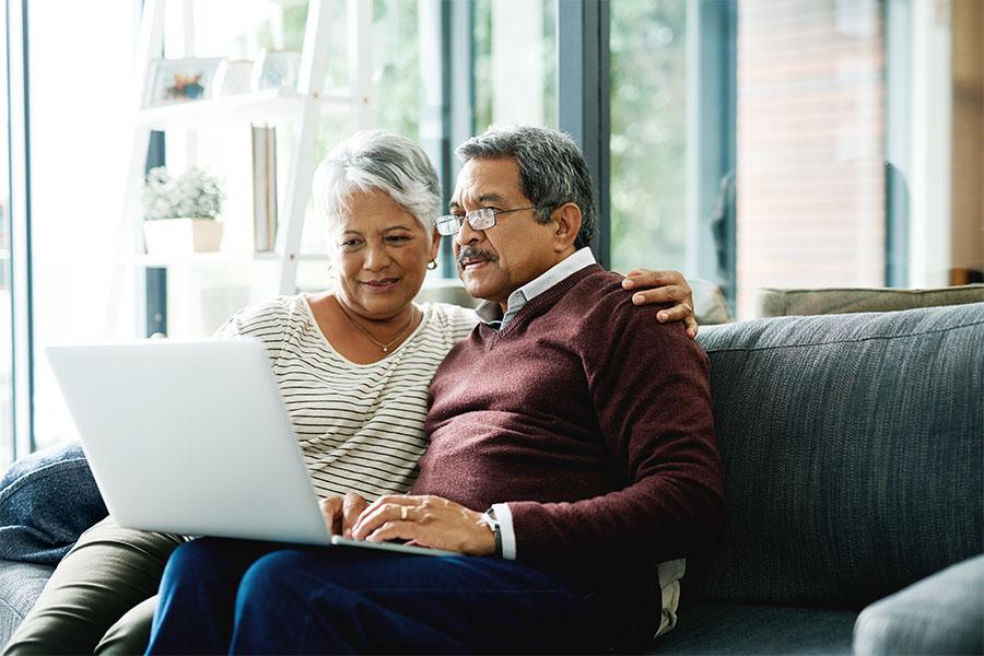 Mature couple researching on their laptop
