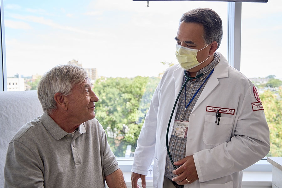 Dr. Nathaniel Marchetti talking with patients