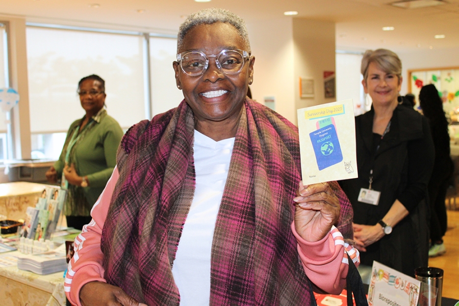 Woman holds up literature about survivorship.
