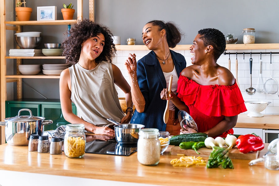 Women happily cooking together