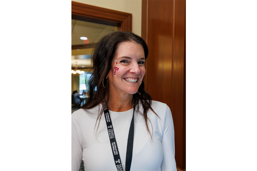 A team member shows off the Temple ‘T’—and a few flowers—at the Women & Families Block Party.