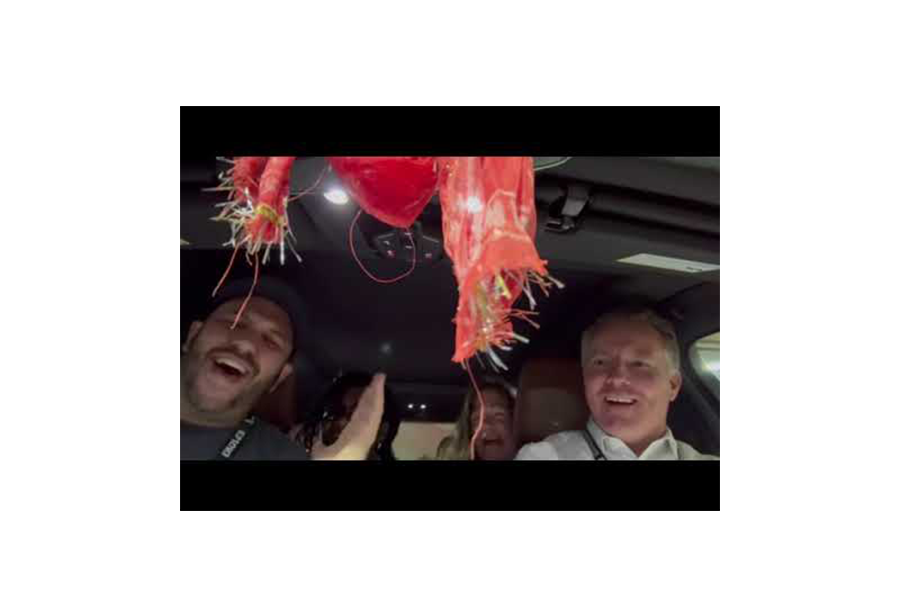 The Malpractice Freaky Finders performing carpool karaoke as a team, with McDevitt on the far right.