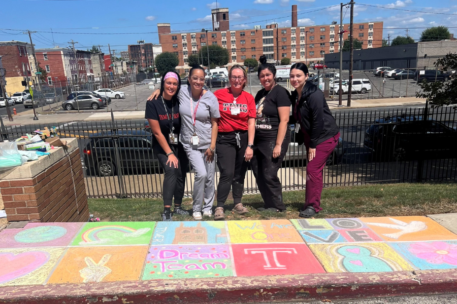 The Dream Team shows off their sidewalk chalk art from a group challenge.