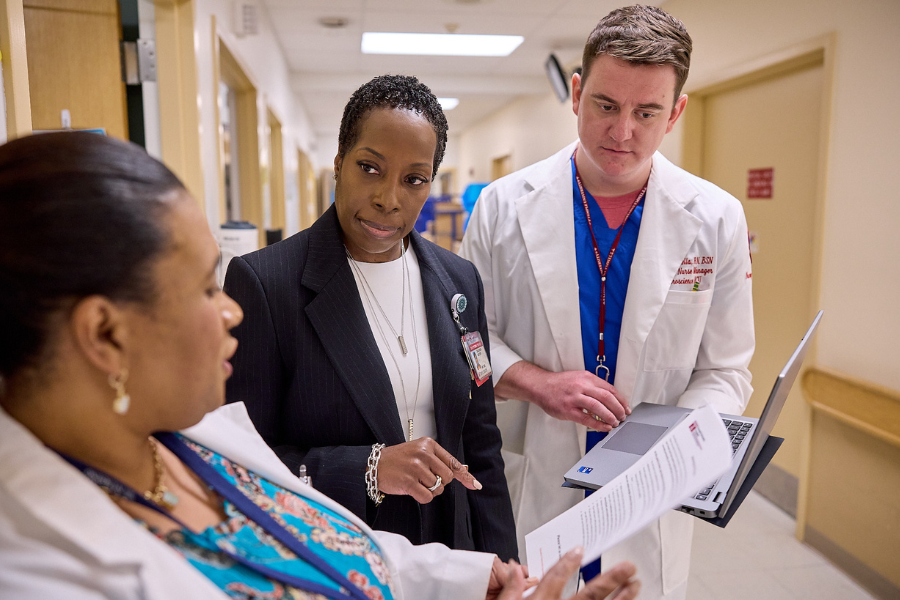 Carter Short reviews documentation with other members of nursing leadership.