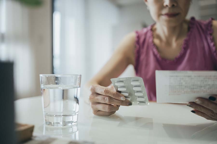 Woman reviewing medication instructions 