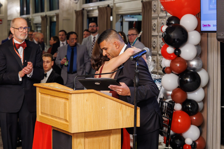 Dr. Catherine Nicolaides, Stephen's mother, hugs Dr. Shenoy after his speech.