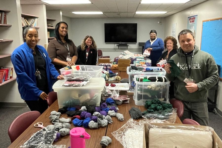 Episcopal staff assemble gift bags to be handed out to patients on Christmas Day.