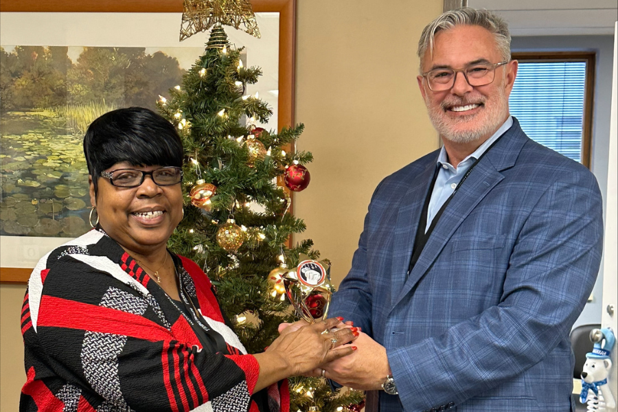 Rich Newell (right), President & CEO of Temple Health-Chestnut Hill Hospital, presents the first-ever bake-off trophy to Betty Shannon (left). 