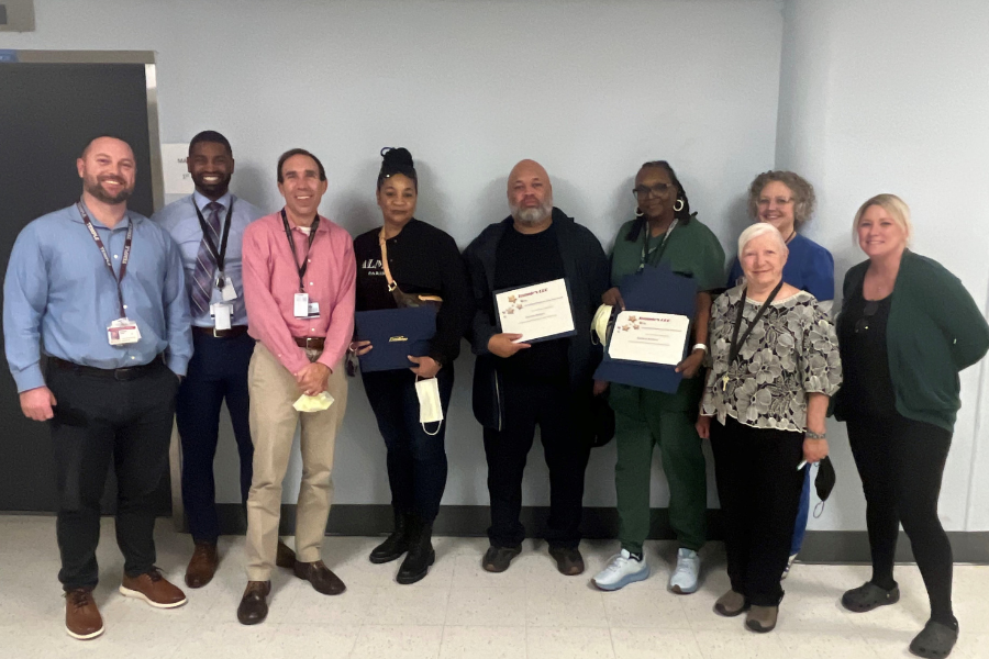 Cromwell, Brothers, and Bradford with leadership and colleagues—including Appolon (second from left)—at the award ceremony. 