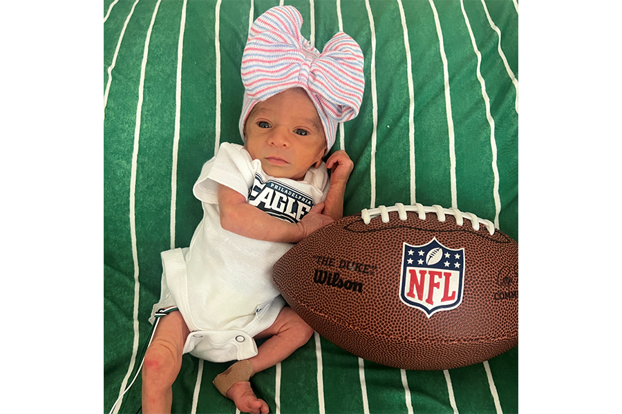 A hat with a bow and a football were perfect accessories for this photoshoot!