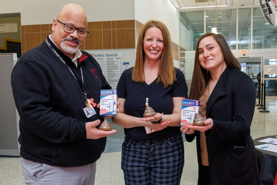 Our team members pose with FIT kits and mini emoji toys.