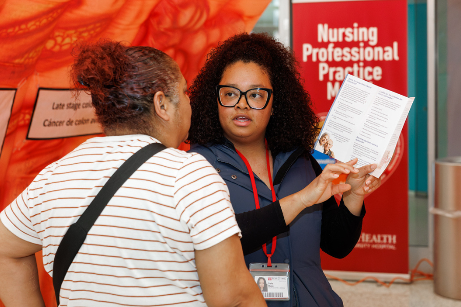 Meja provides colorectal cancer education to an attendee.