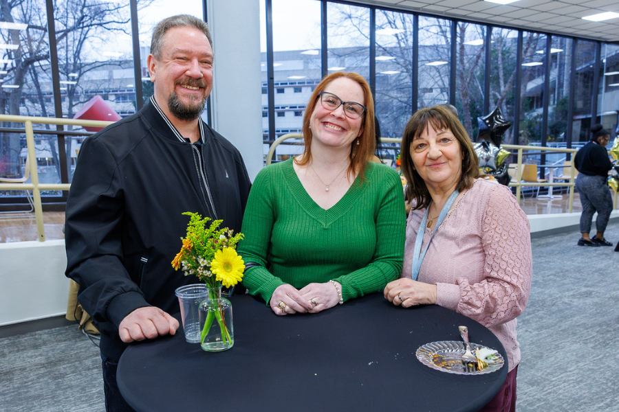 Creative Beginnings Infant Room Teacher Rebeccah Griffin (center) celebrates 25 years at Fox Chase with her husband Brian (left) and Creative Beginnings Program Manager Fabiola DiNiglio (right). 