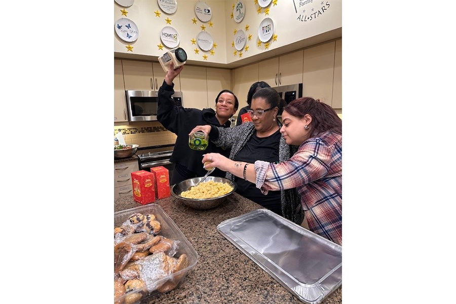 (From left): Indira Kwaadu, Marie Ciceron, and Krystal Cartagena put the finishing touches on their pasta dish.