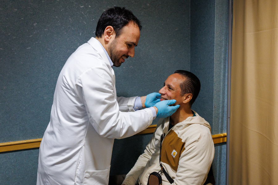 Dr. Jobran Mansour performs a screening on a patient.