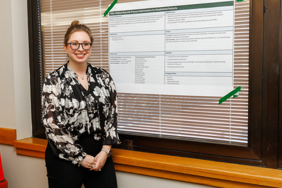 Jordyn Biro, Manager of Service Line Operations, with her poster outlining her project, "Medical Records Process for Established Patients.