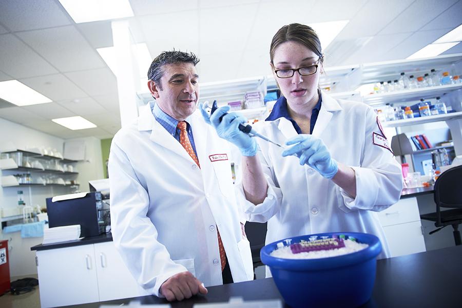 Walter Koch, PhD overseeing research in a lab 