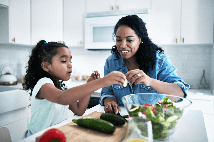 Mother and daughter cooking healthy recipe together