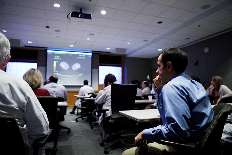 Physicians attend a medical education class