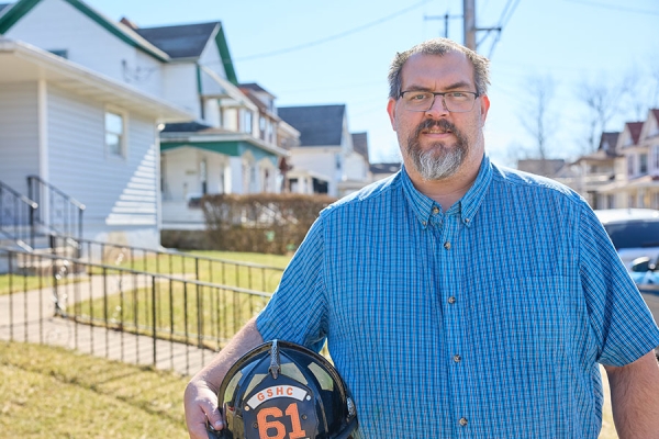 Steve W. holding fireman helmet