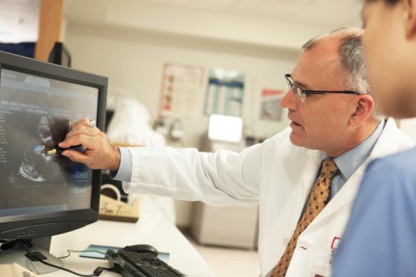 Daniel Edmundowicz, MD examining cardiac imaging monitor