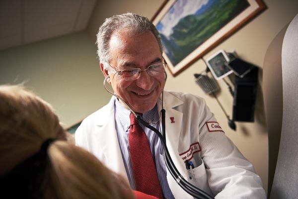 Temple cardiologist Garo Garibian checking a patient