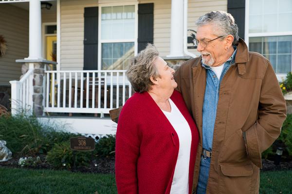 Temple Health COPD patient John happily standing with wife outside their home