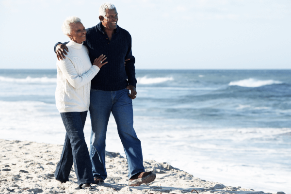 Older couple walking along the beach