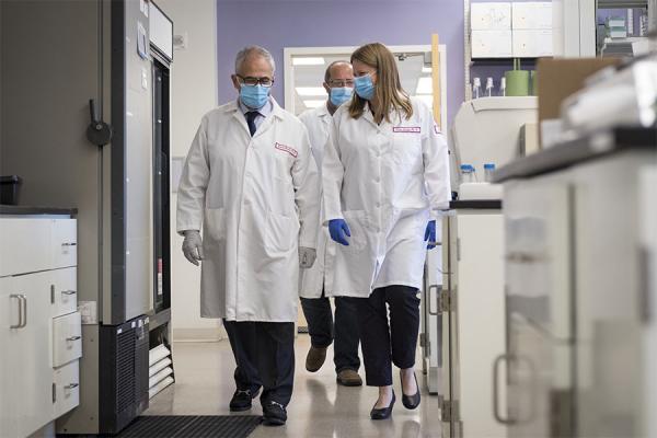 Temple HIV researchers walking through their lab