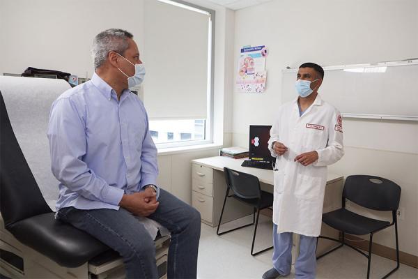 Dr. Kartik Shenoy examining a patient