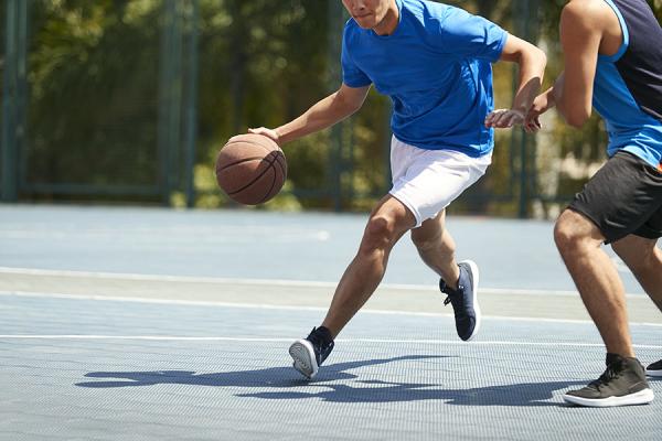 Two men playing basketball on court
