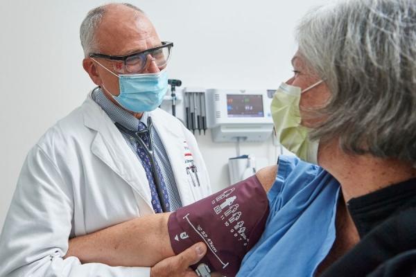 Dr. Edmundowicz checking a patients blood pressure