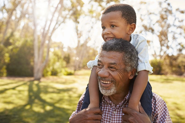 Grandfather holding grandson on his shoulders