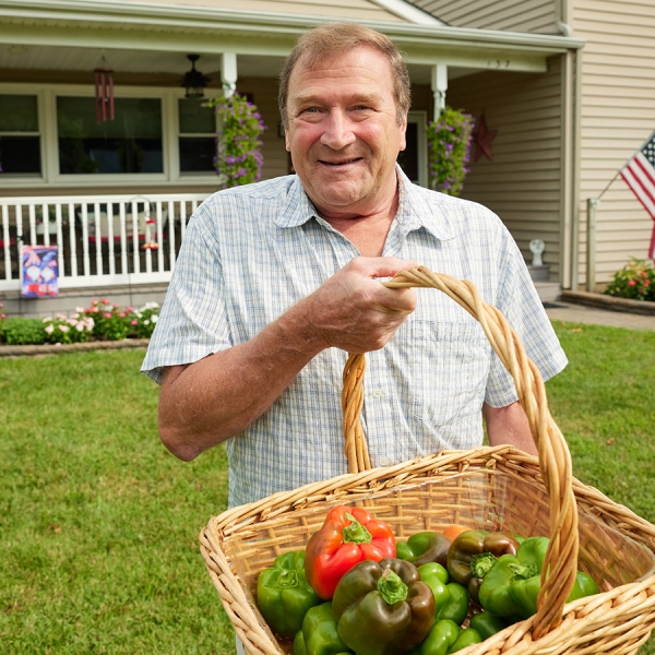 Jim H. holding basket of vegetables