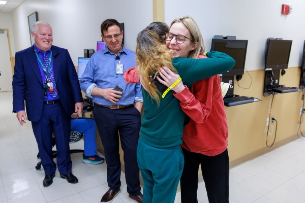 Christie G. and Eida C. embrace.