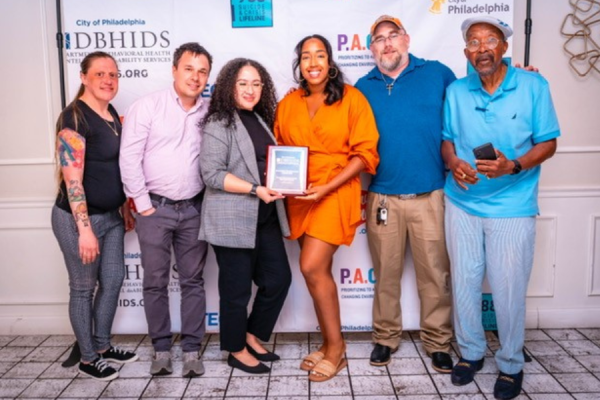 From left: Housing Advocate and Certified Recovery Specialist Lucy Gehan, Certified Peer Specialist Stephen Marino, Director of Substance Use Disorder Engagement Gloria Gonzalez, Director of Therapeutic Programming Briana Stinson, Certified Recovery Specialist Brian Sapp, and Certified Recovery Specialist Arthur Stewart at the presentation ceremony for the award.