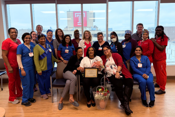Marie Ciceron (center) celebrates her Manager of the Quarter Award with her colleagues