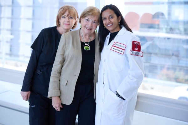 Dr. Vaidya (right) with a patient and a member of the care team.
