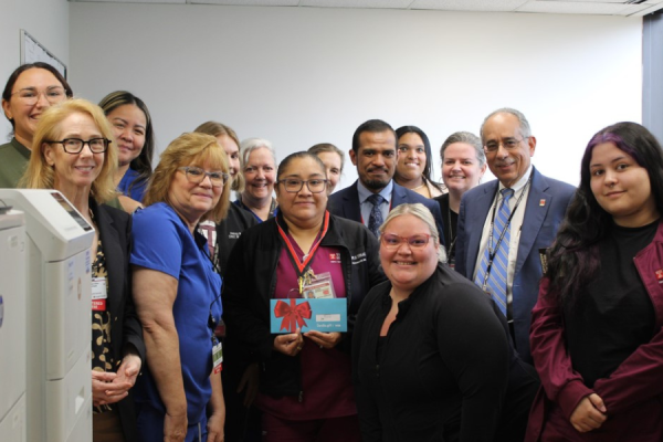 Juana Miranda-Sanchez’s coworkers honor her for her TFP C.A.R.E.S. Award.