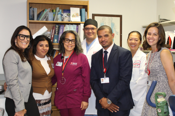 Michelle Clanton-Boykin (center left) and some of her coworkers celebrate her achievement.