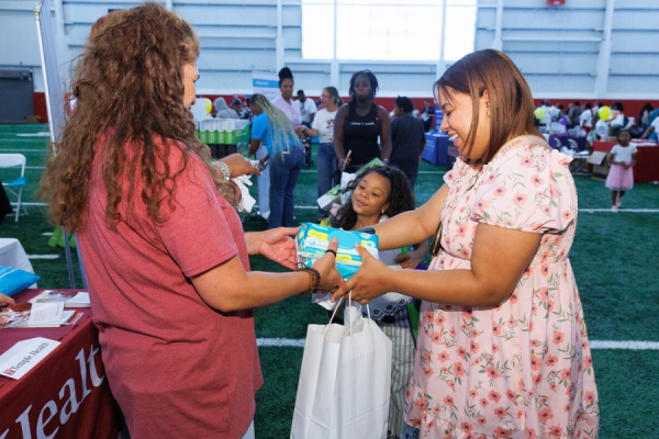 Community members receive resources like baby wipes and more.