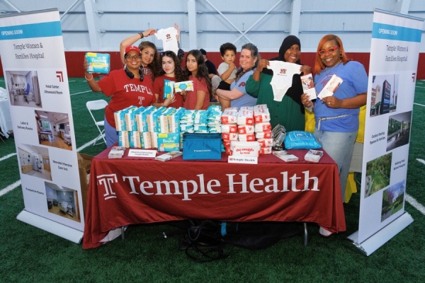 Members of our Temple Health teams offering onesies and supplies, as well as information about Temple Women & Families Hospital.