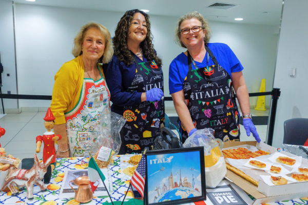 Employees show off Italian food and art pieces.