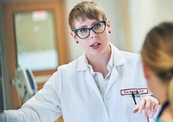 Dr. Erin Narewski talking to another physician in the hospital