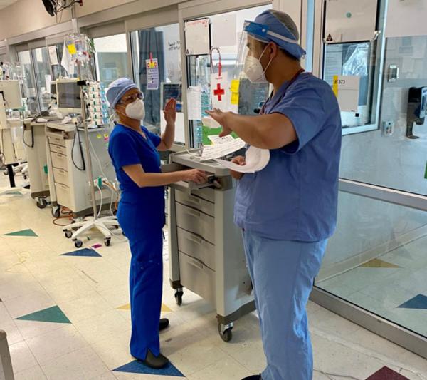 Temple healthcare workers outside Covid patient's room